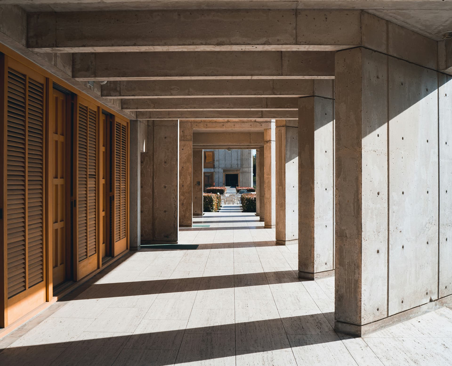 A timber colonnade running through a tropical house